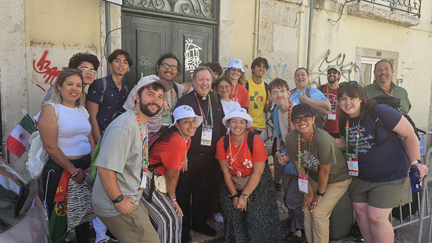 Diocese of Gary pilgrims and those from St. Francis Xavier, Lake Station, enjoy World Youth Day activities in Lisbon, Portugal with Bishop Robert J. McClory (center). The diocesan group volunteered to lead morning Rise Up catechetical sessions during the event for English-speaking pilgrims from around the world, including one by Bishop McC.lory exploring the experience of being loved and called by the Lord. (Provided photo)