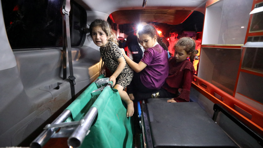 Children sit in the back of an ambulance at Shifa Hospital following an airstrike on the CNEWA-supported al-Ahli Arab Hospital in Gaza City Oct. 17, 2023. (OSV News photo/Mohammed Al-Masri, Reuters) EDITORS: Note graphic content.