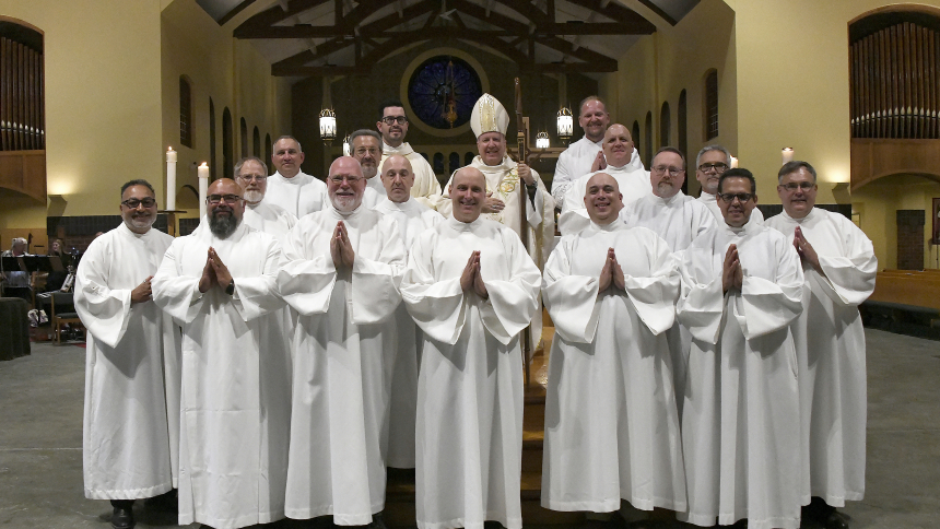 At the conclusion of the Institution to the Ministry of Acolyte and Deacon Jubilee Mass on Sept. 14, Bishop Robert J. McClory (top, center) stands with Father Leonardo Gajardo (top, left), director of diaconate formation (pre-ordination) and 15 diocesan diaconal candidates who were admitted to the next ministerial role on their Journey to becoming permanent deacons, at St. Michael the Archangel church in Schererville. Also at the liturgy, clergymen were honored for achieving landmark anniversaries of their 