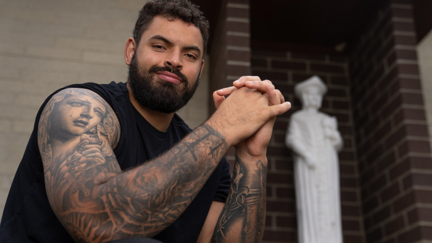 Abraham "Abe" Lucas, an offensive tackle for the Seattle Seahawks, poses outside St. Thomas More Catholic Church in Lynnwood, Wash., Sept. 3, 2023. Lucas speaks volumes about being Catholic through the images tattooed on his arms, including the Virgin Mary. (OSV News photo/Stephen Brashear, Northwest Catholic)