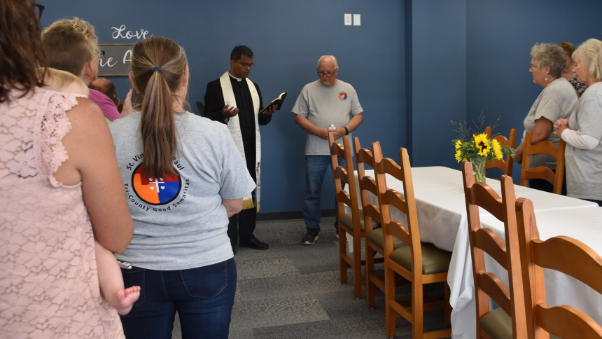 Father Sengole Gnanaraj, administrator of St. Elizabeth Ann Seton Parish in Richmond, Ind., says a prayer before using holy water to bless David's House in Richmond Sept. 10, 2023. Tony Talbert, looking on at right, is president of the Tri-County Good Samaritans conference of the Society of St. Vincent de Paul, which opened the center as a new ministry. (OSV News photo/Natalie Hoefer, The Criterion)