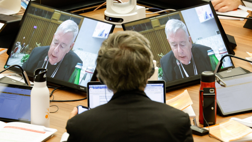 Cardinal Jean-Claude Hollerich, relator general of the synod, is seen on a video screen as he introduces the fourth section of the working document at a session of the assembly of the Synod of Bishops in the Vatican's Paul VI Audience Hall Oct. 18, 2023. (CNS photo/Lola Gomez)
