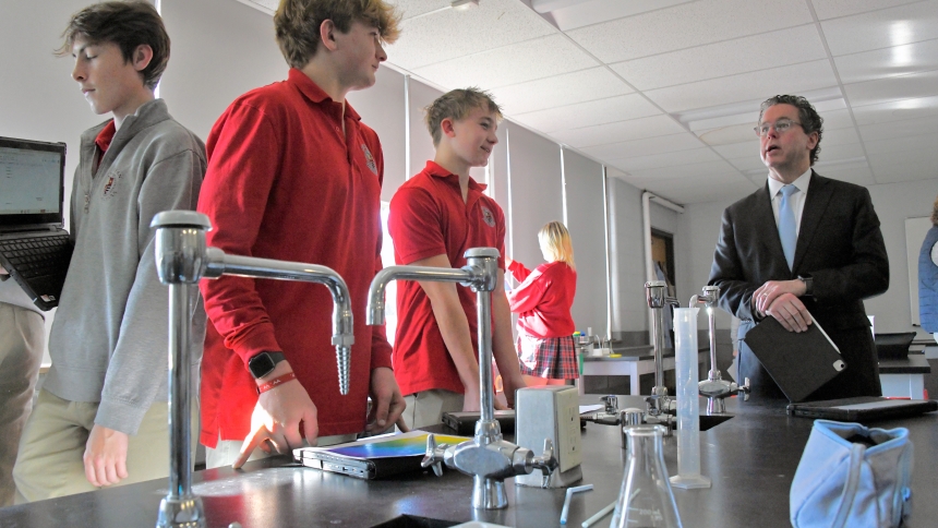Andrean High School freshmen Mitchell Myers (second from left) and Mitchell Cadwallader (center) discuss a science project with Big Shoulders Fund president and chief executive officer Joshua Hale (right) in a laboratory at the Merrillville school during Lend A Shoulder Day on Nov. 15. At the third annual academic and philanthropic event, three diocesan schools hosted professionals from throughout the Region who then attended a lunch presentation at the Lighthouse Restaurant in Cedar Lake. (Anthony D. Alonz