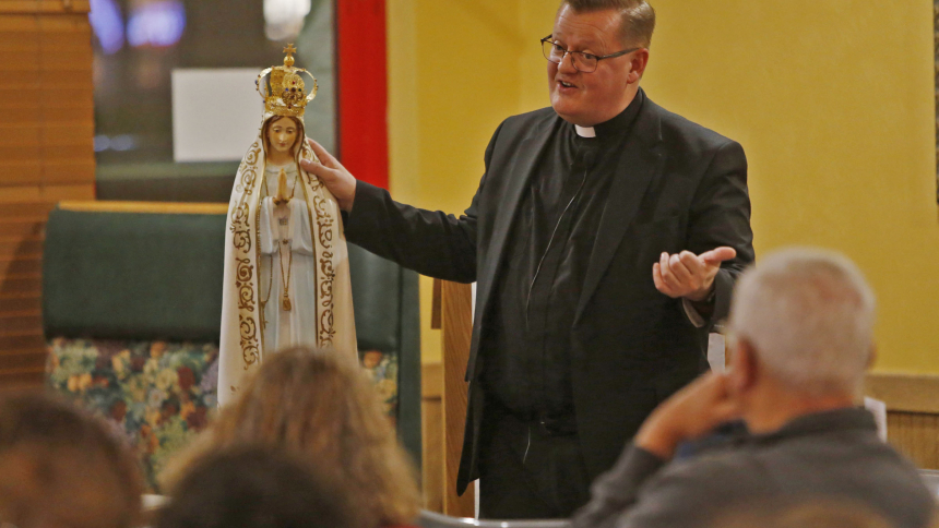 Father David Kime, pastor of Queen of All Saints, talks about Our Lady of Fatima during the QAS Tapped-In series on October 18. The four week series featured talks on the Blessed Mother. The event was held at Gelsossomo's Pizzaria. (Bob Wellinski photo)