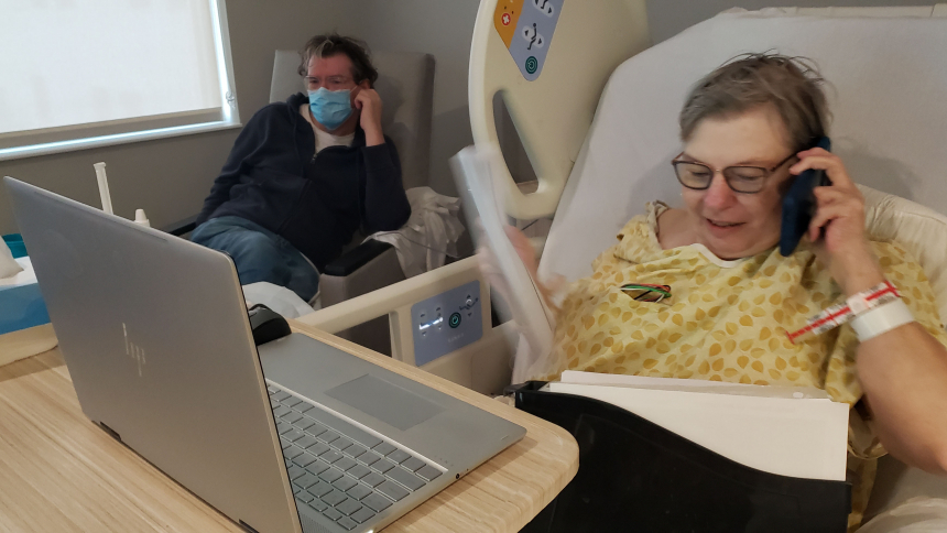 Terminal cancer didn't stop mom (Pat Wellinski) from continuing to do her job as a bookkeeper from a hospital bed a month prior to her passing. Her son, Greg, sits in a chair beside her. (Bob Wellinski photo)