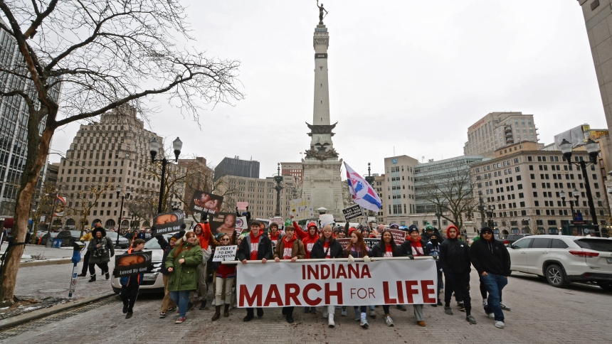 More than 2,000 pro-life advocates, led by Mater Dei High School of Evansville students holding the official signage for the Indiana March for Life, pass the Soldiers' and Sailors' Monument and make their way up Meridian Street in Indianapolis on Jan. 22. More than 50 diocesan faithful joined the events, traveling by a chartered bus to attend Mass presided over by Archbishop Charles C. Thompson of Indianapolis in the Indiana Convention Center, followed by the march, which led to the south lawn of the state 