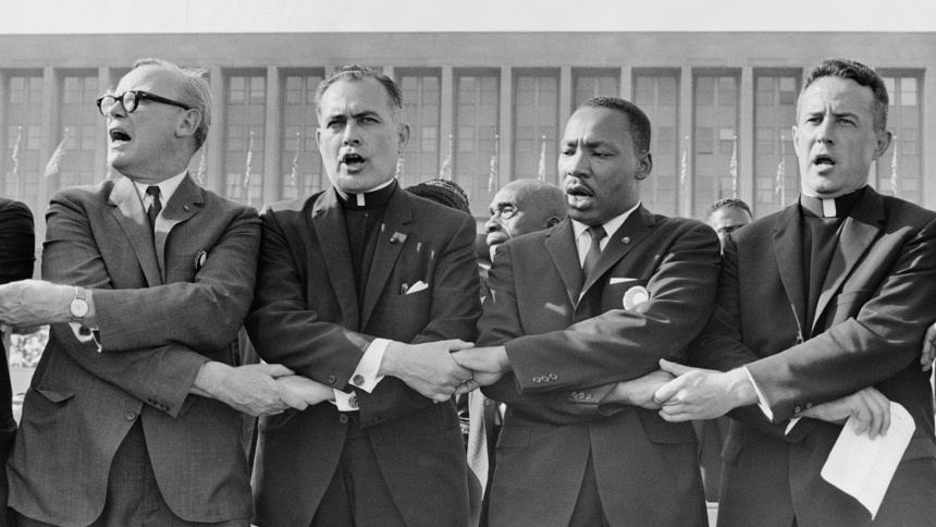 Holy Cross Father Theodore Hesburgh, then president of the University of Notre Dame, second from left, joins hands with the Rev. Dr. Martin Luther King Jr., the Rev. Edgar Chandler and Msgr. Robert J. Hagarty of Chicago, far right, in this 1964 file photo. As Rev. King taught, "we must confront the evils of racism and prejudice with the love of Christ," Archbishop Timothy P. Broglio of the U.S. Archdiocese for the Military Services, who is president of the U.S. Conference of Catholic Bishops, said in a Jan.