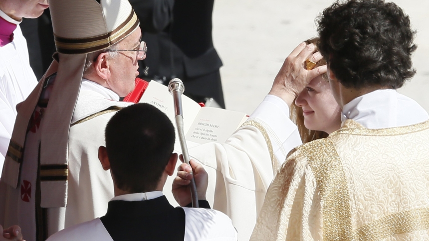Pope Francis administers the sacrament of confirmation to Brigid Miniter, 14, of Ridgewood, N.J., during a Mass in St. Peter's Square at the Vatican April 28. The pope confirmed 44 people from 22 countries. (CNS photo/Paul Haring) 
