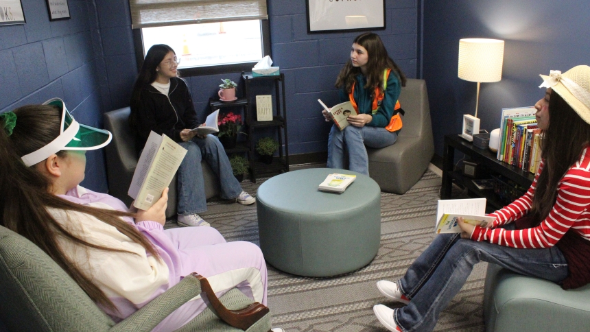 A cozy reading nook is available in the Title I reading resource room added last fall at Aquinas Catholic Community School in Merrillville. Taking advantage of it for some quiet reading on Jan. 31 during Catholic Schools Week are eighth graders (from left) Vanessa Ruiz, Vanessa Huizar, Kayla Douts and Yaritza Favela. "It's calmer here," said Huizar, while Favela said the facility allows students to "be connected" as they learn. (Marlene A. Zloza photo)