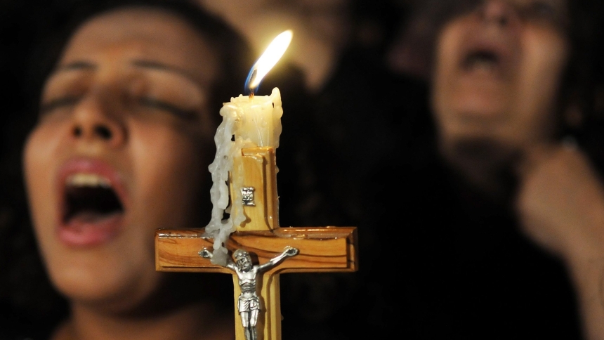 A crucifix is pictured in a file photo as Coptic Christians pray in Cairo. In the Coptic Orthodox Archdiocese of South Africa, three  Egyptian Coptic monks were brutally murdered March 12, 2024, in their monastery in Cullinan, a small town about 18 miles east of the capital, Pretoria. (OSV News photo/stringer via Reuters)  