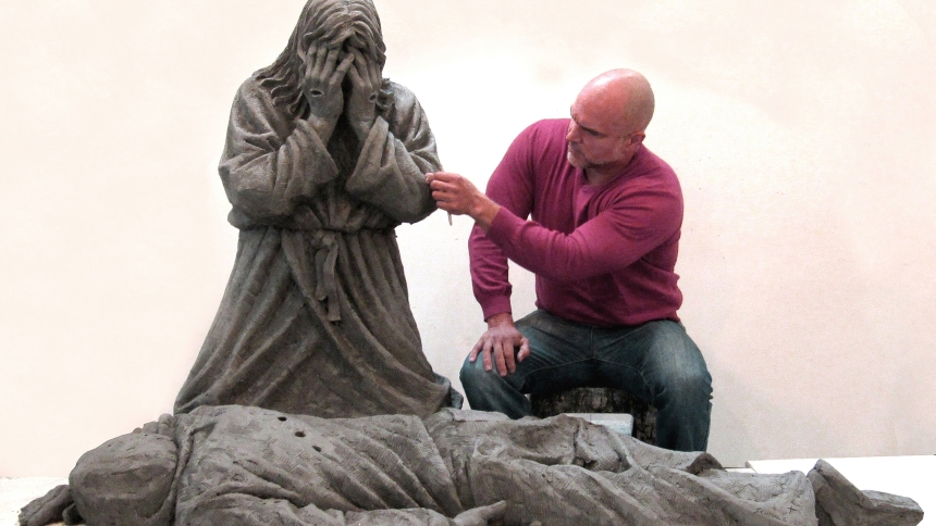 Canadian-based artist Timothy P. Schmalz is pictured in an undated photo working on his life-sized clay sculpture titled "Thou Shalt Not Kill," which depicts Jesus kneeling over a victim of gun violence. Some 60 people gathered March 25, 2024, outside of St. Sabina Catholic Church in Chicago for a first look at the sculpture, which the artist donated to the parish. (OSV News photo/Timothy P. Schmalz)