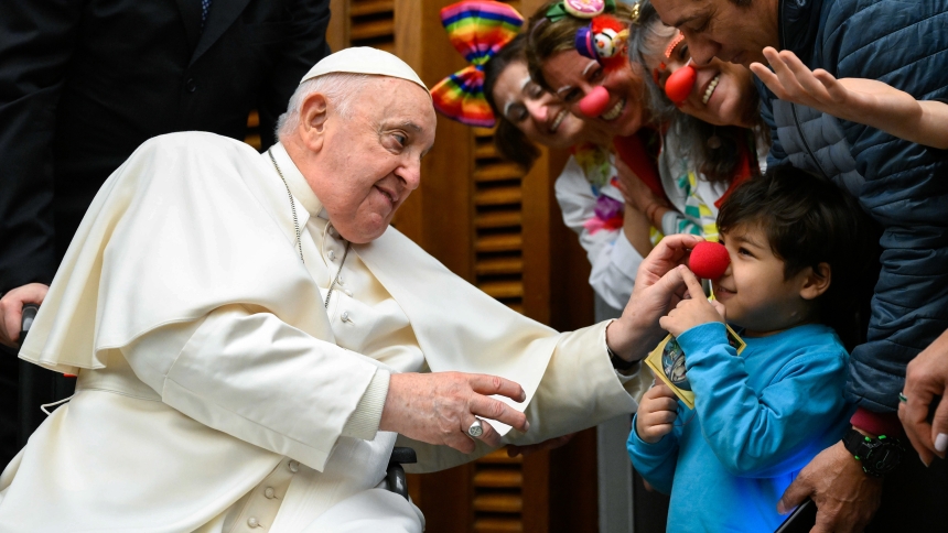 Pope Francis shares a playful moment with a child during a meeting with staff and patients from the Vatican-owned Bambino Gesù pediatric hospital in the Vatican's Paul VI Audience Hall March 16, 2024. (CNS photo/Vatican Media)