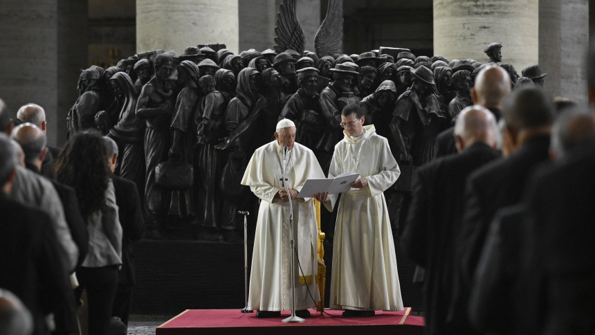 Pope Francis leads members of the assembly of the Synod of Bishops in praying for migrants and refugees in front of the statue, "Angels Unawares," in St. Peter's Square Oct. 19, 2023. The sculpture by Canadian Timothy Schmalz, depicts a boat with 140 figures of migrants from various historical periods and various nations. (CNS photo/Vatican Media)