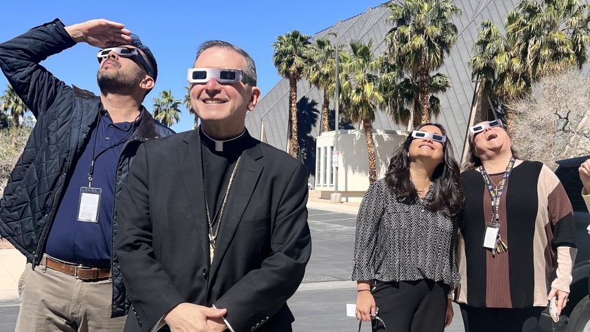 Auxiliary Bishop Gregory W. Gordon of Las Vegas and chancery staff look outside at the partial eclipse in Las Vegas April 8, 2024. A partial eclipse was visible throughout all 48 contiguous U.S. states, while a total solar eclipse was visible along a narrow track stretching from Texas to Maine. (OSV News photo/Montie Chavez, courtesy Archdiocese of Las Vegas)